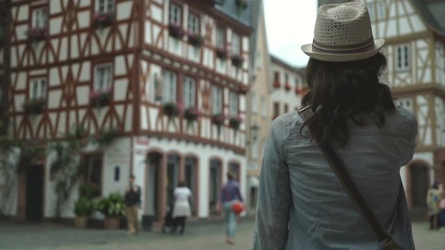 Girl in town center admiring traditional german houses