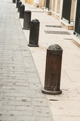 Anti-parking bollards in narrow cobbled street