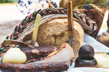 Onions, bacon and homemade sausage on the table