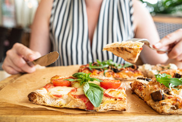 woman eating pizza in the restaurant