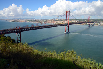 Fototapeta premium The 25 April bridge (Ponte 25 de Abril) is a steel suspension bridge crossing the Targus river, Lisbon, Portugal