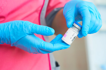 Nurse holding a medical solution for dropper in hands and prepare to putting medicine inside it. Injection preparation in hospital.