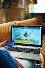 Fototapeta premium housewife with credit card using travel hotel booking website