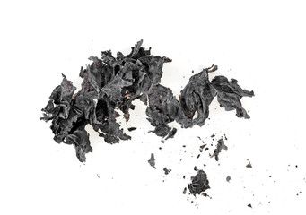 Ashes of the paper on a white background. Burned paper.