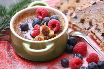 Very tender and tasty dessert with fresh berries it is called Creme Brule
