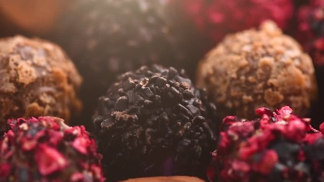 Truffle chocolates. Assorted chocolate praline candies background. Rotation. Slow motion. 4K UHD video footage. 3840X2160