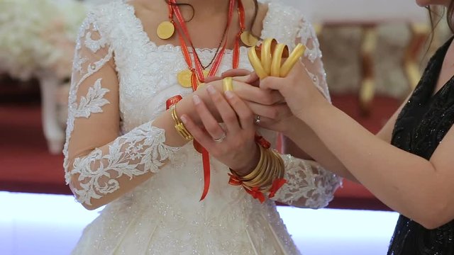 Traditional turkish wedding, bride hands and arms arrayed with gold bracelet