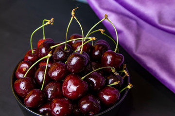 cherries in black containers on the table