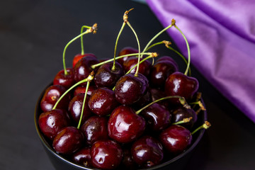 cherries in black containers on the table