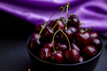 cherries in black containers on the table