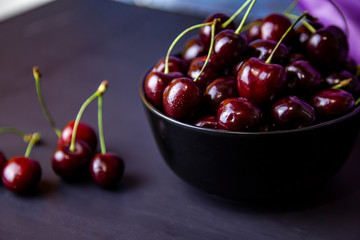 cherries in black containers on the table