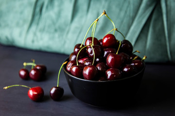 cherries in black containers on the table