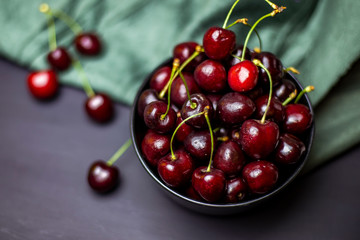 cherries in black containers on the table