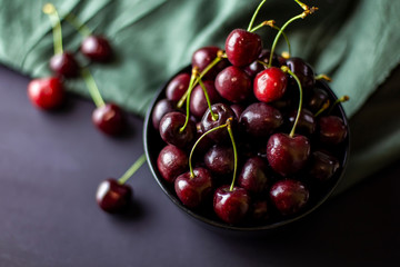 cherries in black containers on the table