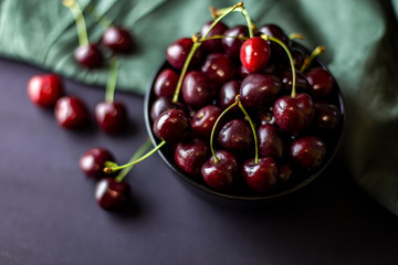 cherries in black containers on the table