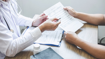 Professional doctor in white uniform gown coat and patient discussing consults to treatment of symptom disease and making prescriptions