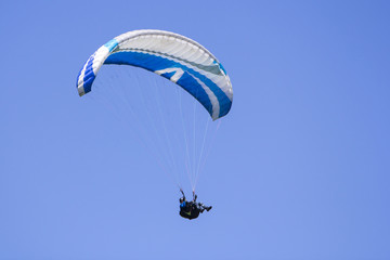 Paragliding in the blue sky as background extreme sport
