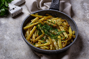 Stewed yellow wax beans in pan