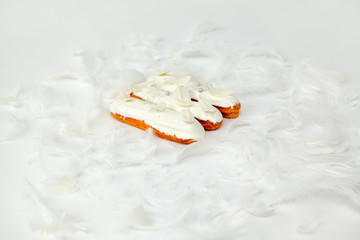 A set of three eclairs with white chocolate decor isolate on a white surface decorated with white...