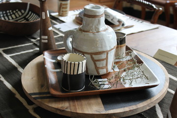 A setting of hand made pottery rests on a lazy susan.