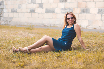 Young beautiful young sexy sporty girl with naughty smile outside in summer.