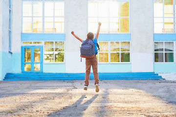 happy little boy, high jumped with joy, the beginning of the school year.happy child goes to primary school. positive attitude to study.