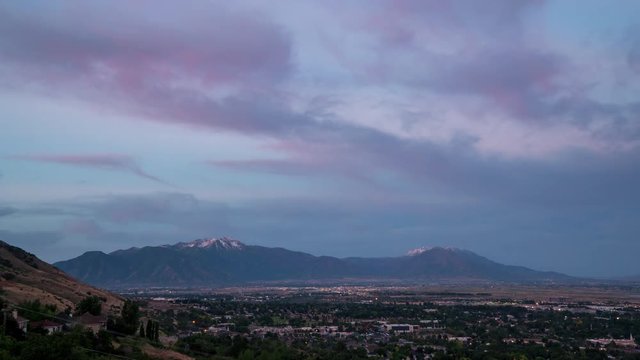 Colorful sunrise time lapse looking over Provo towards Spanish Fork viewing the cities across the valley and Nebo Mountain in the distance.