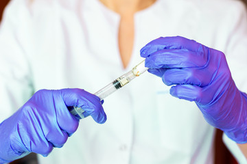 Woman hands holding syringe ampoule