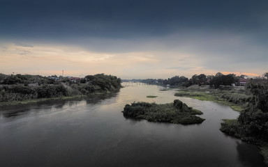 river view evening of Mae Klong River with raining and cloudy sky background, Nakhon Chum, Ban Pong, Ratchaburi, Thailand.