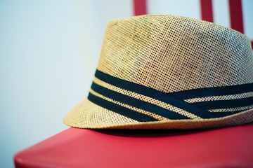 brown derby cap on red chair