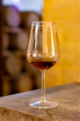 Tasting of fortified dry or sweet marsala wine in vintage wine cellar with old oak barrels in Marsala, Sicily, Italy