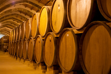 Vintage wine cellar with old oak barrels, production of fortified dry or sweet marsala wine in Marsala, Sicily, Italy