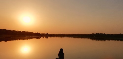 silhouette of fisherman at sunset