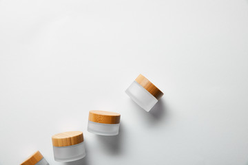 top view of jars with wooden caps on white