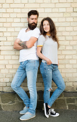 Urban youth on date. Casual meeting. Man bearded and girl friends. Couple in love romantic date huddle outdoors brick wall background. Casual couple in love. Boyfriend and girlfriend romantic date