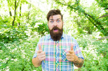 Naklejka na ściany i meble Summer vacation concept. Explore wild nature activity. Man bearded hipster green trees background. Emotional nature lover. Man handsome beard and mustache in summer forest. United with environment