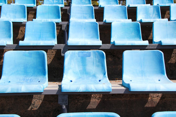 old blue stadium seats in a row