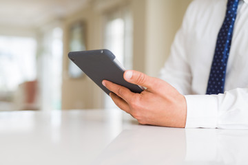 Close up of middle age business man using tablet