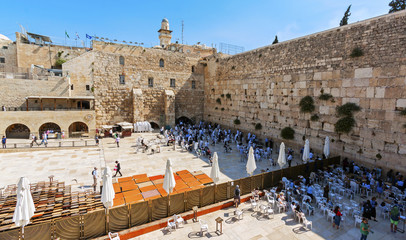 Fototapeta premium Praying people at the Wailing Wall. Visible division into two separate parts - for men and for women. Temple Mount, Jerusalem, Israel