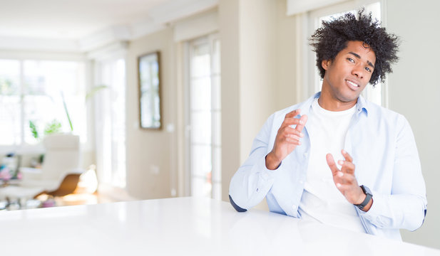 African American man at home disgusted expression, displeased and fearful doing disgust face because aversion reaction. With hands raised. Annoying concept.