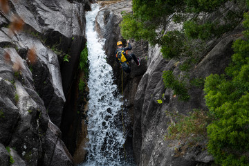Cascata do Arado, Vilar da Veiga, Portugal - June 10, 2019: One man rappelling the Arado Waterfall...
