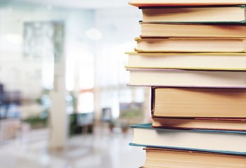 Stack of colorful books on blurred background