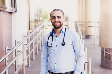 Closeup portrait of professional male asian medical student. People - a doctor, a nurse and a surgeon on the background of the university's educational clinic. Health insurance. Medical Education