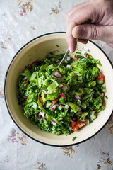 Summer light salad in a yellow iron Cup