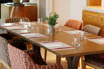 casual restaurant dining table set up, with dark brown color theam