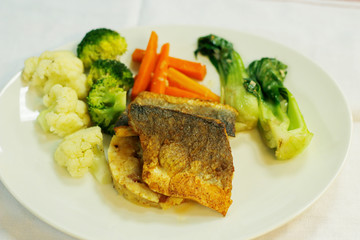 pan siered sea bass fillet with mashed potatoes and steamed vegetables
