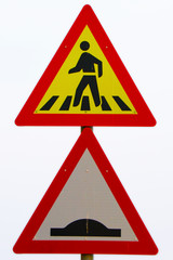 pedestrians walking along the road with bumb sign, yellow and red board with white background