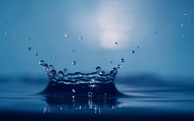 water splash like a crown on a dark color blurred background