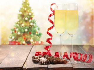 Naklejka na ściany i meble Champagne in glasses, red ribbon and chocolate isolated on white