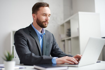 Man working on the laptop in the office.